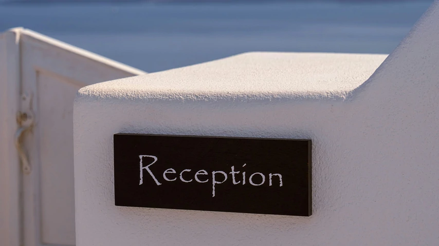 hotel reception sign on a white wall